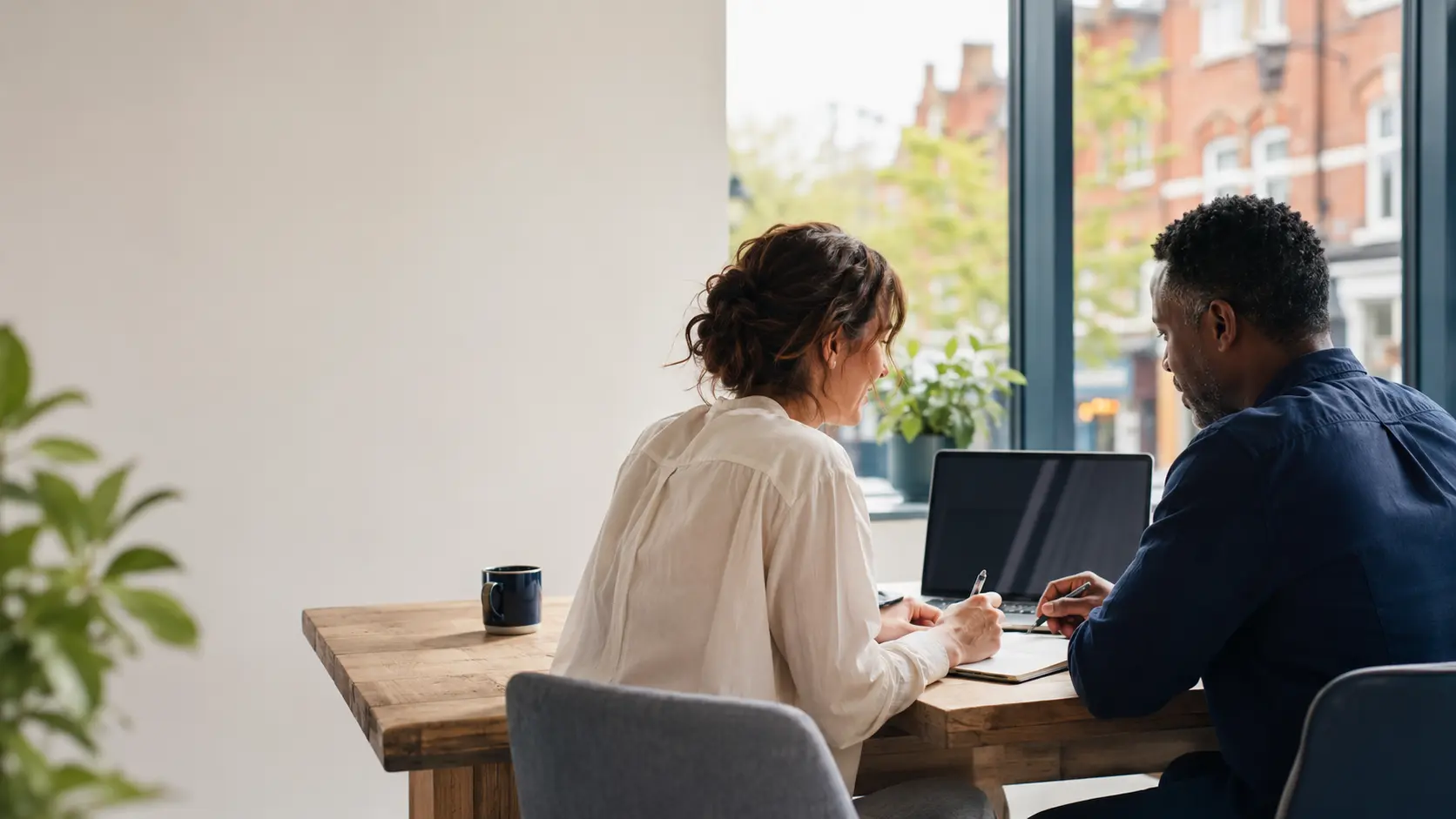 Two small-business owners reviewing their requirements together in a calm workspace
